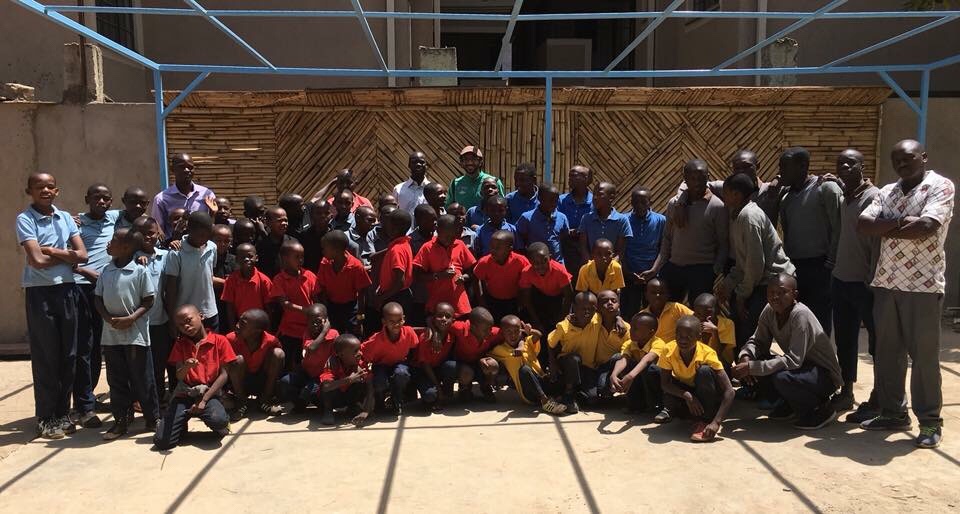 The Raha Kids family — dozens of boys and their caregivers gathered together in the courtyard in Nairobi