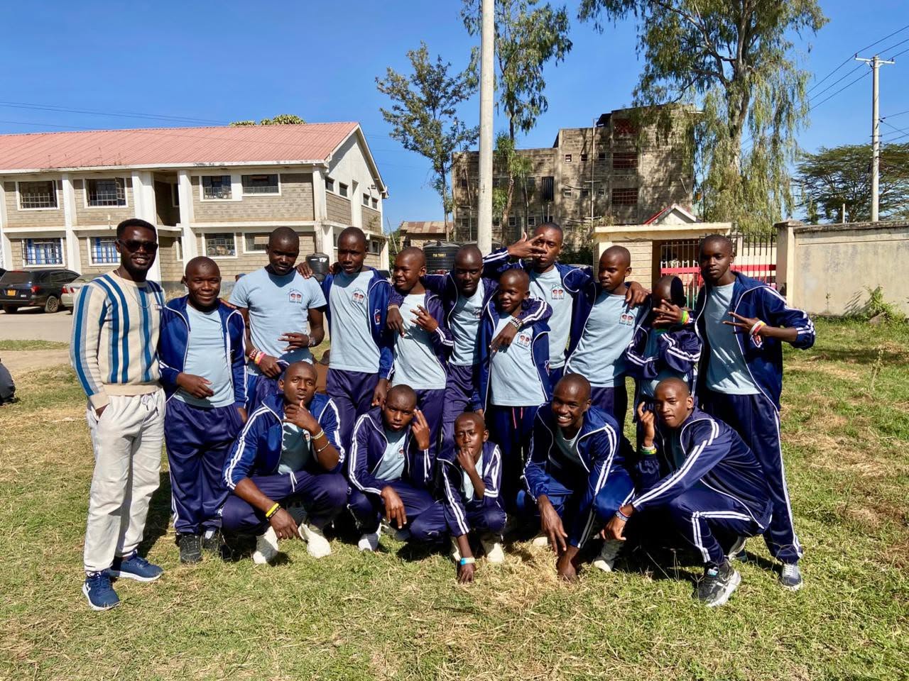 The Raha Kids sports team in matching tracksuits posing together on a field before a match